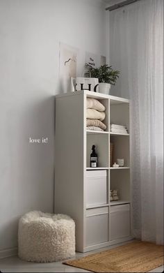 a white shelf with towels and other items on it