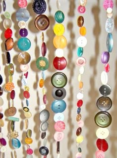 a bunch of buttons are hanging on the wall