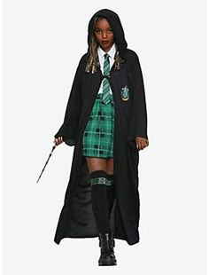 a woman dressed in a harry potter costume and holding a wand while standing on a white background