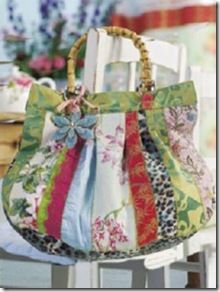 a colorful purse sitting on top of a white chair next to a table with flowers