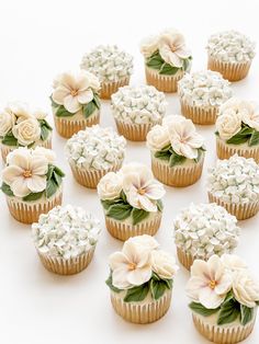 there are many cupcakes with flowers on them