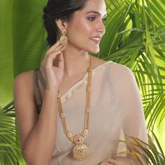 The gold beaded chain necklace that sizzles the room, this long necklace is royal charm. Excellent to pair with a kanjivaram or handloom saree. Specification: Weight - 100 gm (necklace); 19 gm (earring); Length - 36 cm (necklace); 8 cm (earring), 100% Satisfaction Guarantee:  1 Year Warranty, Long Lasting Plating, High-Quality Stones. Gifting:  This Indian long necklace set comes in a beautiful Tarinika gift box, making it an ideal gift for birthday, wedding anniversary or wedding gift.  Occasion: Perfect choice for any Indian occasion.  Care: It is advisable that you keep Tarinika products away from direct heat, humidity, and moisture. It is best to preserve your Tarinika jewelry in the box. Return/Exchange Policy:  We provide 14 days return/exchange policy. Contact us for any questions. Indian Long Necklace, Indian Jewelry Set, Long Necklace Set, Necklace Set Indian, Gold Necklace Indian, Indian Necklace, Indian Jewelry Sets, Gold Necklace Designs, Antique Necklace