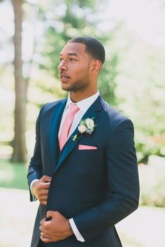 a man in a suit and pink tie