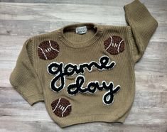 Football Game Day Hand Embroidered Baby and Toddler Sweaters the cutest football fan hand embroidered sweaters for babies + toddlers. These are great for baby shower gifts, baby announcement, birthday, holiday, milestone, etc!  Have a favorite school or sports team?? Customize your colors to help represent + support your teams!! Feel free to message with any questions to get your best color combos! production time is currently 2-3 weeks. If you need the sweater sooner, you can purchase a rush op Sports First Birthday, Embroidery Sweater Diy, Hand Embroidered Sweater, Embroidered Sweaters, Football Baby Shower, Christmas Toddler, Fan Hand, Crochet Baby Sweater, Toddler Sweater