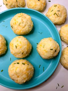 several biscuits on a blue plate with green sprinkles and some lemon zest