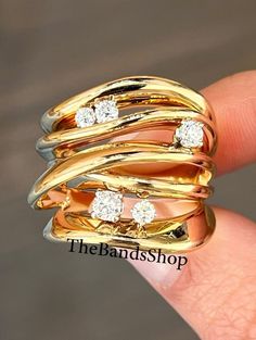 a gold ring with three diamonds on it