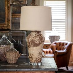 a lamp sitting on top of a table next to a chair