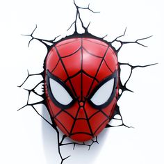 a spiderman mask is shown on the wall behind it's cracked up branches