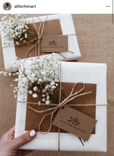 two wrapped packages with flowers tied to them