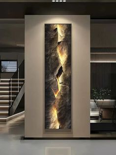 an abstract painting is hanging on the wall in a modern room with stairs leading up to it