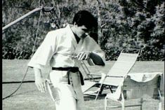 a man standing next to a lawn chair