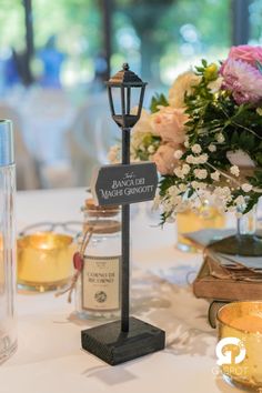 a table with flowers and candles on it