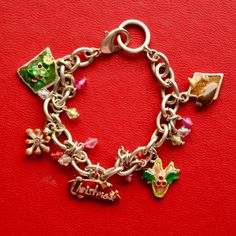 Celebrate the festive season in style with this Christmas Cheer Charm Bracelet! This charming vintage piece features an 8-inch silver-toned chain adorned with five holiday-themed enamel charms, including a Christmas tree, snowflake, holly, a martini glass, and the word "Christmas!" in festive script. To add extra sparkle and elegance, shimmering crystal beads dangle between the charms, creating beautiful movement and a touch of sophistication. This bracelet is the perfect holiday accessory or a thoughtful gift for someone who loves unique, festive jewelry. Key Features: -8 inches in length -Silver-toned chain with secure clasp -Five enamel holiday-themed charms -Crystal bead accents between each charm for added sparkle Perfect for: -Holiday parties and gatherings -Christmas gifts -Vintage Charm Bracelet Vintage, Christmas Tree Snowflake, Vintage Charm Bracelet, Stylish Bracelet, Bracelet Vintage, Enamel Charms, Vintage Holiday, Beaded Dangles, Martini Glass