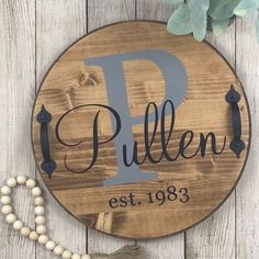 a wooden sign that says pullen est 19083 with beads on the ground next to it