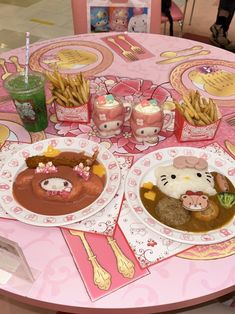 a hello kitty themed birthday party with food and drinks on the table, including french fries