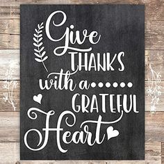 a black and white sign that says give thanks with a grateful heart on the front