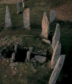 an aerial view of stonehenge standing in the middle of a field with grass and rocks