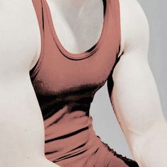 a woman in a red tank top sitting down