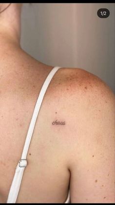 the back of a woman's shoulder with words on it that say cheeses