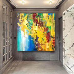 an abstract painting hangs in the entry way