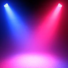 two spotlights in the middle of a stage with red and blue lights on it