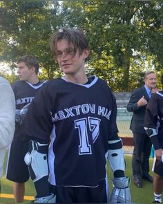 a young man standing on top of a soccer field