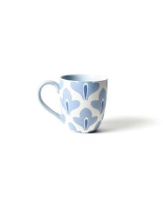 a blue and white coffee cup sitting on top of a table