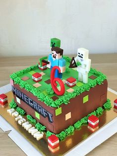 a cake made to look like a minecraft video game with characters on top and green grass