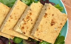 four pieces of bread sitting on top of a green salad