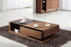 a coffee table with two cups on it and a shelf in the middle that is open