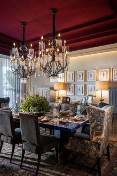 a formal dining room with chandelier and chairs