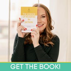 a woman holding up a book in front of her face with the title get the book