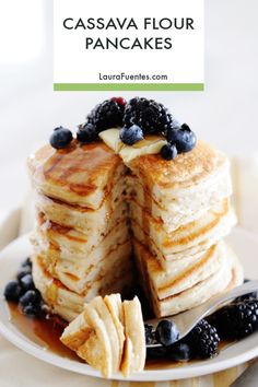 a stack of pancakes with blueberries and syrup