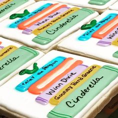 decorated cookies with name tags on them sitting on a table