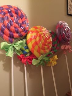 three lollipops are on top of each other and tied to the wall