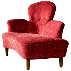 an upholstered red chair with wooden legs and footrests, on a white background