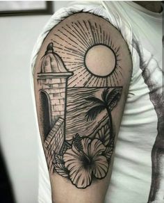 a man's arm with tattoos on it and an image of a lighthouse in the background