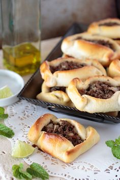 several pastries on a tray with mint leaves