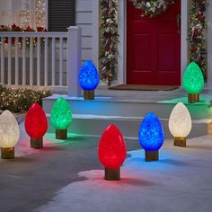 christmas lights are lit up in front of a house