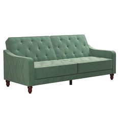 a green couch sitting on top of a white floor