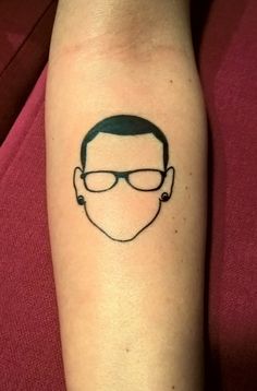 a man's face with glasses on his left arm is shown in black ink