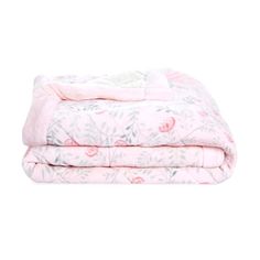 the pink floral blanket is folded on top of each other