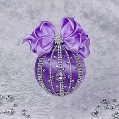 a purple ornament with a bow on it