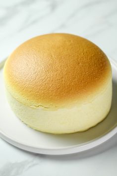 a white plate topped with a yellow cake