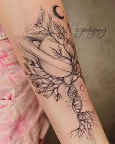 a woman's arm with a black and white tattoo design on the left forearm