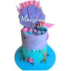 a little mermaid themed cake with pink and blue frosting on it's top