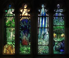 three stained glass windows with animals and trees in them