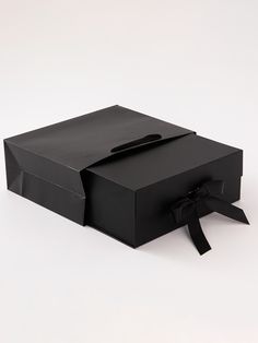 an open black box with a bow on it