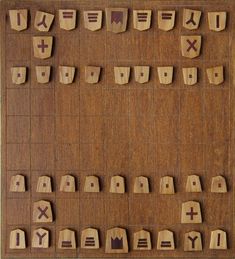 a wooden board game with numbers and symbols on the boards, all in different shapes and sizes