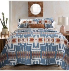 a bed in a room with a blue and orange comforter